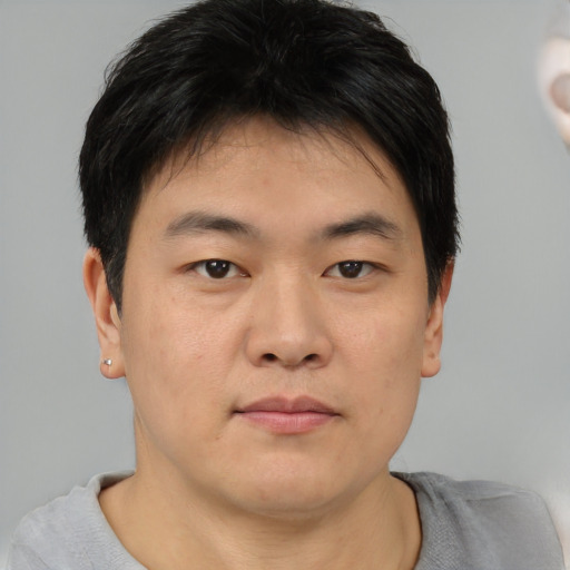 Neutral asian young-adult male with short  brown hair and brown eyes