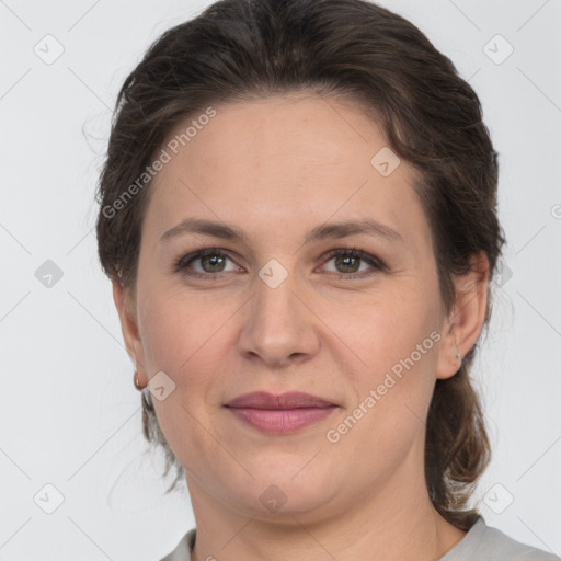 Joyful white adult female with medium  brown hair and grey eyes