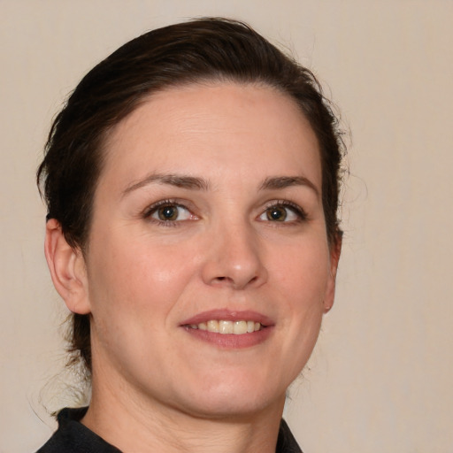 Joyful white young-adult female with medium  brown hair and brown eyes