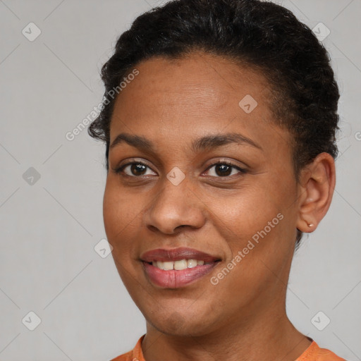 Joyful black young-adult female with short  brown hair and brown eyes