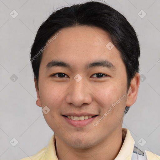 Joyful asian young-adult male with short  brown hair and brown eyes