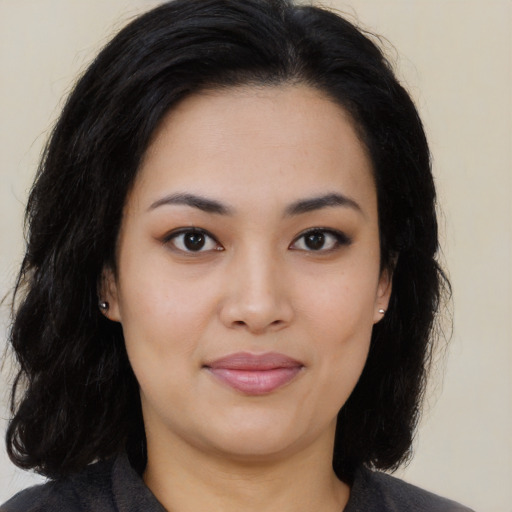 Joyful latino young-adult female with long  black hair and brown eyes
