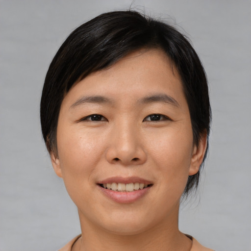 Joyful asian young-adult female with medium  black hair and brown eyes
