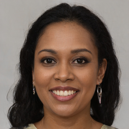 Joyful latino young-adult female with medium  brown hair and brown eyes