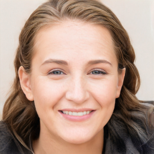 Joyful white young-adult female with long  brown hair and blue eyes