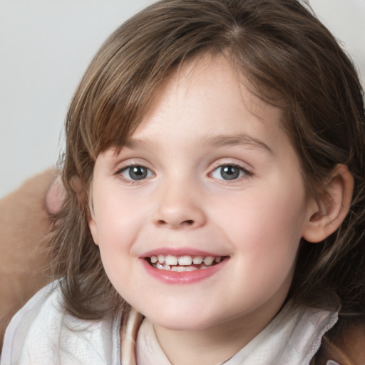 Joyful white child female with medium  brown hair and grey eyes