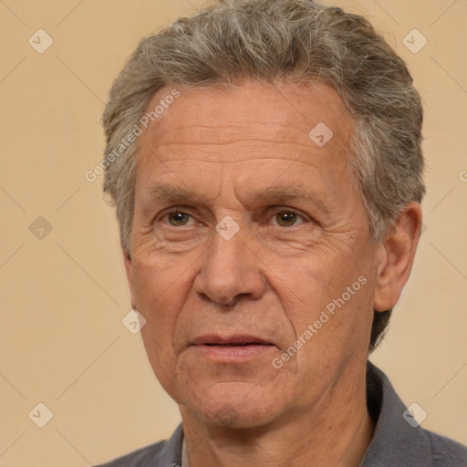 Joyful white middle-aged male with short  gray hair and brown eyes