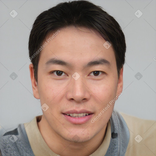 Joyful asian young-adult male with short  brown hair and brown eyes