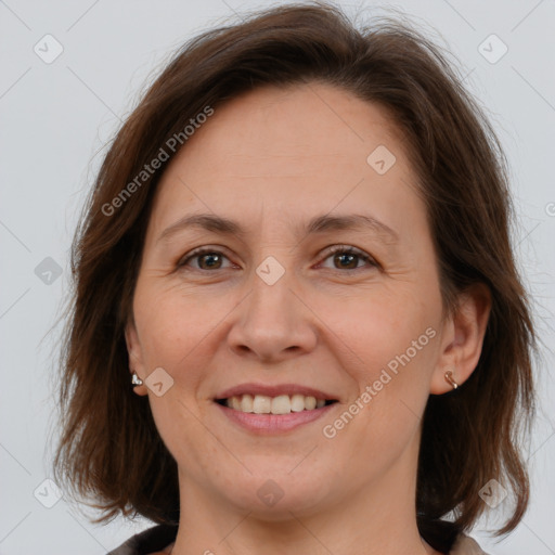 Joyful white adult female with medium  brown hair and brown eyes