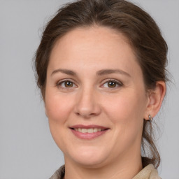 Joyful white adult female with medium  brown hair and brown eyes