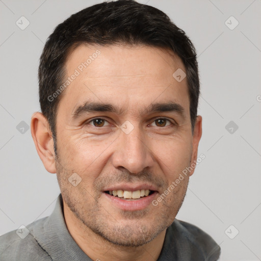 Joyful white adult male with short  brown hair and brown eyes