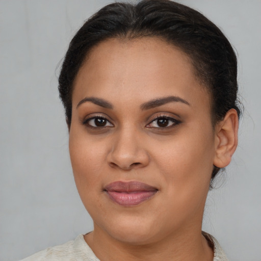 Joyful latino young-adult female with short  brown hair and brown eyes