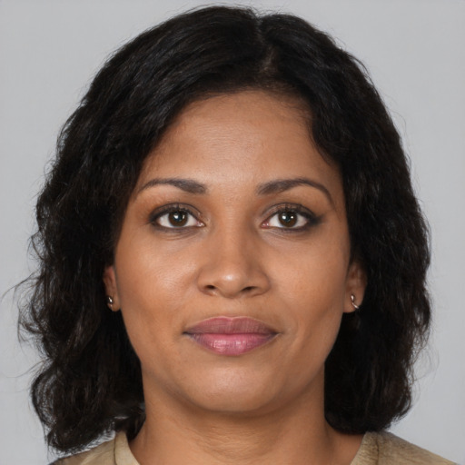 Joyful black young-adult female with medium  brown hair and brown eyes