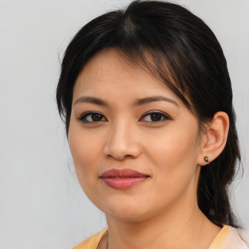 Joyful asian young-adult female with medium  brown hair and brown eyes