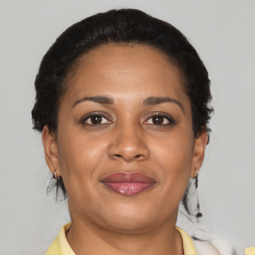 Joyful latino young-adult female with short  brown hair and brown eyes