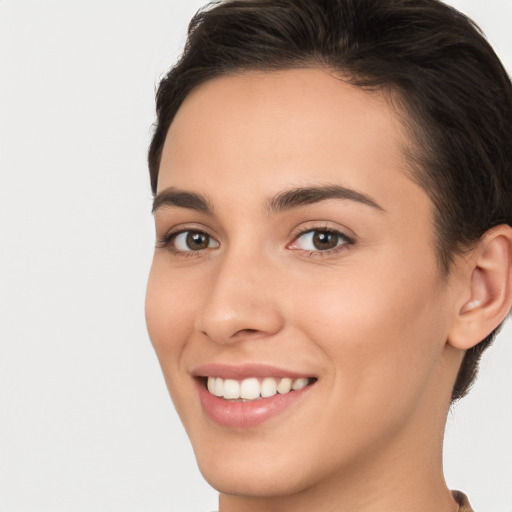 Joyful white young-adult female with short  brown hair and brown eyes