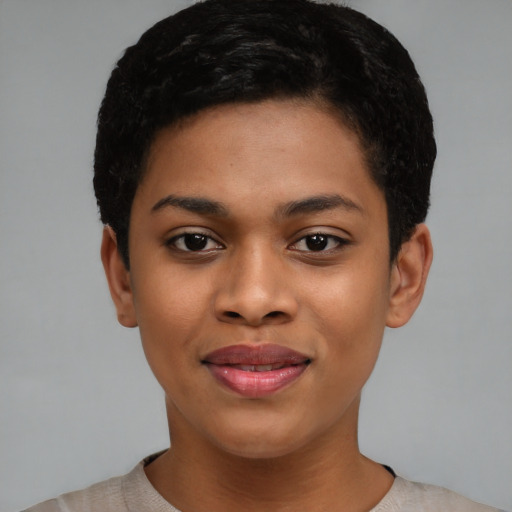 Joyful black young-adult female with short  black hair and brown eyes