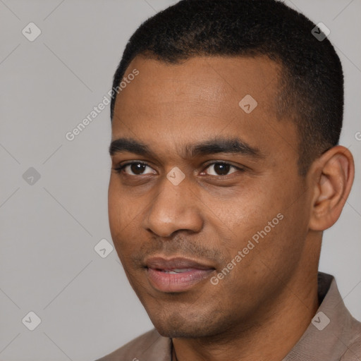 Joyful black young-adult male with short  black hair and brown eyes