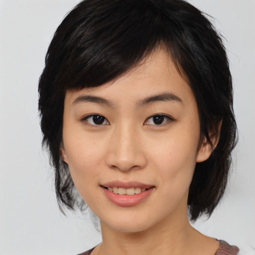 Joyful asian young-adult female with medium  black hair and brown eyes