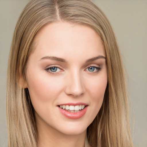 Joyful white young-adult female with long  brown hair and green eyes