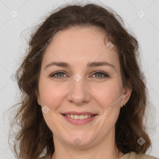 Joyful white adult female with long  brown hair and brown eyes