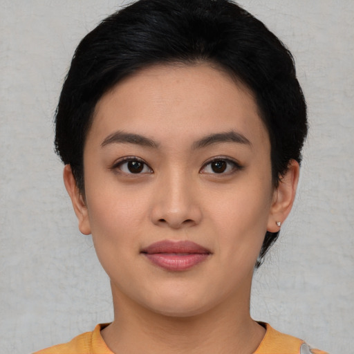 Joyful asian young-adult female with short  black hair and brown eyes