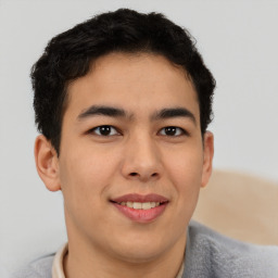 Joyful latino young-adult male with short  brown hair and brown eyes