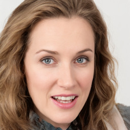 Joyful white young-adult female with long  brown hair and blue eyes