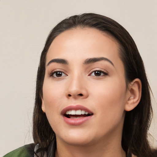 Joyful white young-adult female with long  black hair and brown eyes