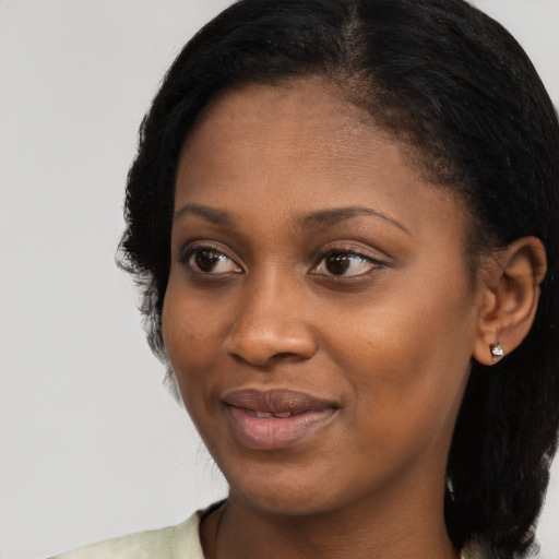 Joyful black young-adult female with medium  black hair and brown eyes