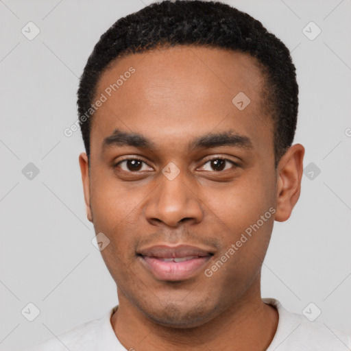 Joyful black young-adult male with short  black hair and brown eyes