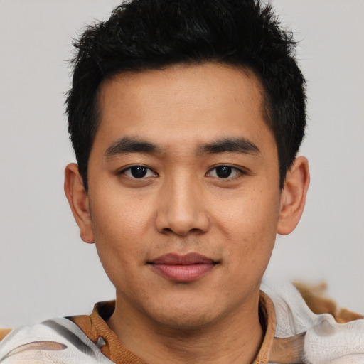 Joyful asian young-adult male with short  black hair and brown eyes