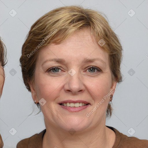 Joyful white adult female with medium  brown hair and grey eyes