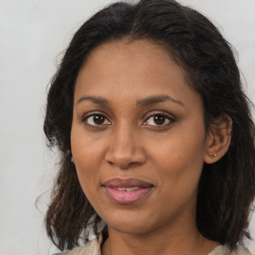 Joyful black adult female with medium  brown hair and brown eyes