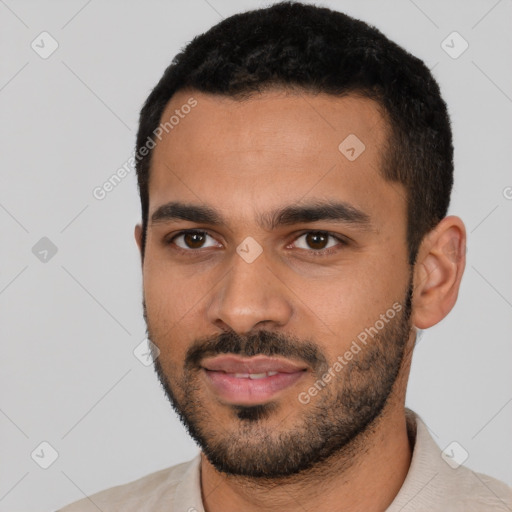 Joyful latino young-adult male with short  black hair and brown eyes