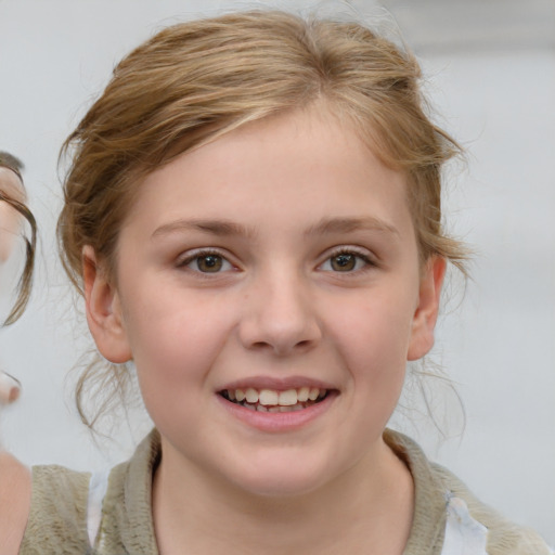 Joyful white child female with medium  brown hair and brown eyes