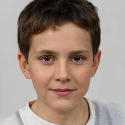 Joyful white child male with short  brown hair and brown eyes