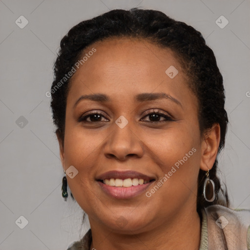 Joyful black young-adult female with long  brown hair and brown eyes