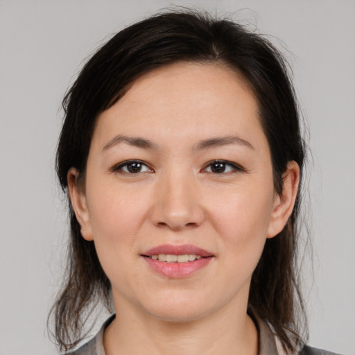 Joyful white young-adult female with medium  brown hair and brown eyes