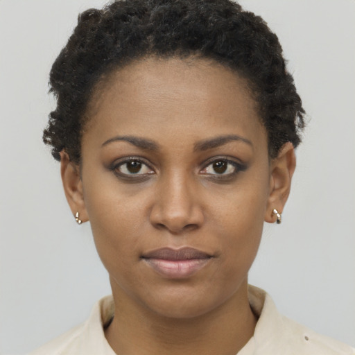 Joyful black young-adult female with short  brown hair and brown eyes