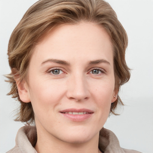 Joyful white adult female with medium  brown hair and blue eyes