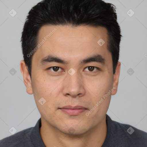 Joyful white young-adult male with short  black hair and brown eyes