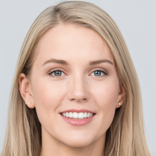 Joyful white young-adult female with long  brown hair and blue eyes