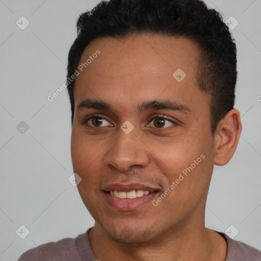 Joyful latino young-adult male with short  black hair and brown eyes