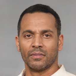Neutral latino adult male with short  black hair and brown eyes