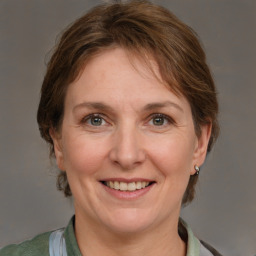 Joyful white adult female with medium  brown hair and grey eyes