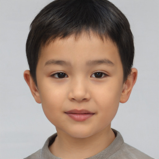 Joyful asian child male with short  brown hair and brown eyes