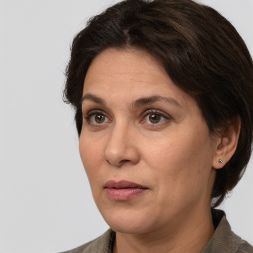 Joyful white adult female with medium  brown hair and brown eyes