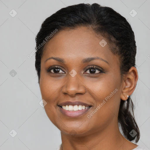 Joyful black young-adult female with medium  brown hair and brown eyes