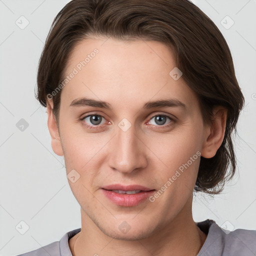 Joyful white young-adult female with short  brown hair and grey eyes